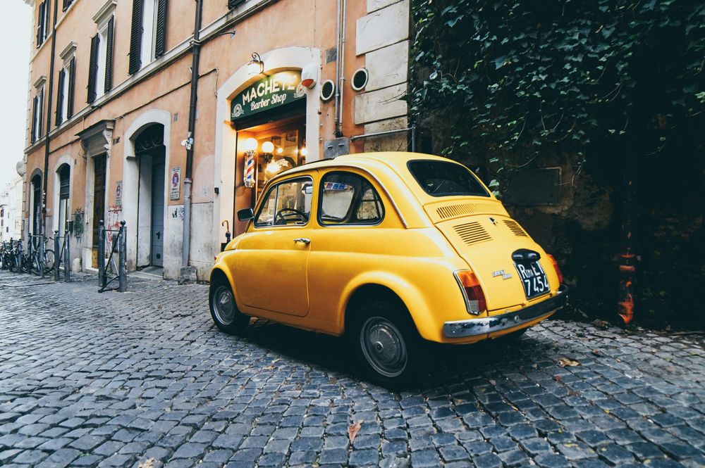An old car in Rome representing how to of from Rome to Florence