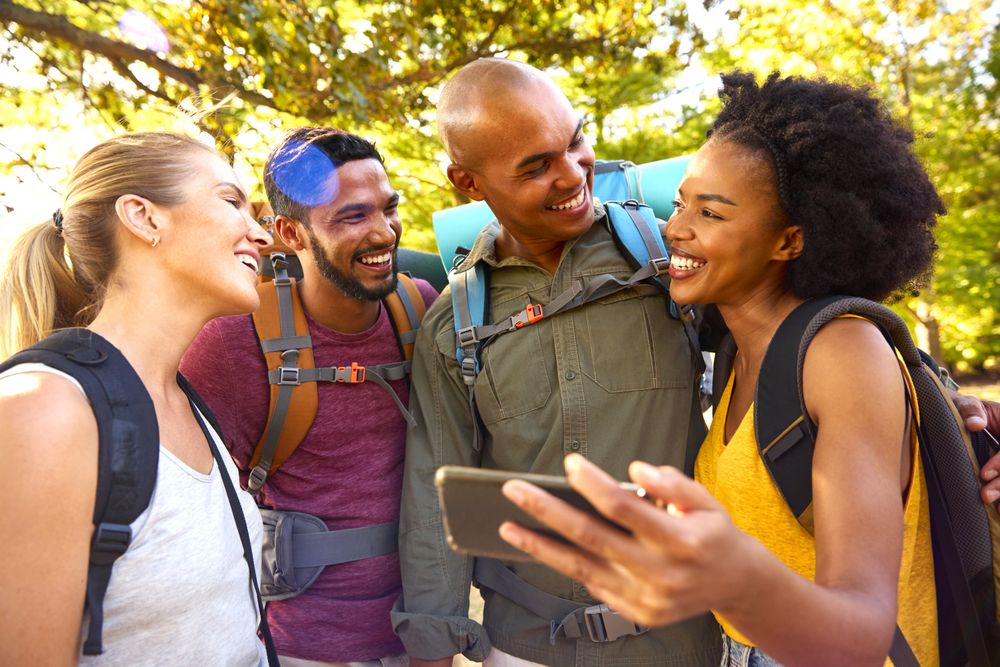 Travelers checking their Travel WhatsApp Groups while Traveling