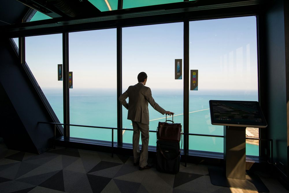 Man waiting in the airport, representing Business Trip Planning