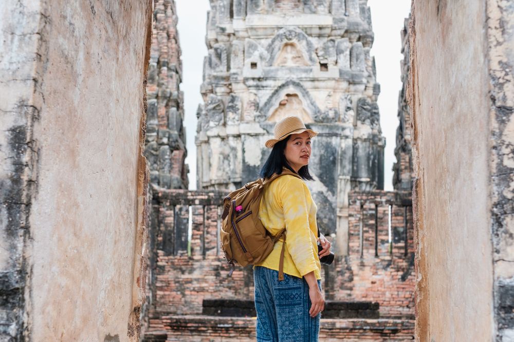 Woman in Thailand carrying her backpack as a way to follow travel safety advice