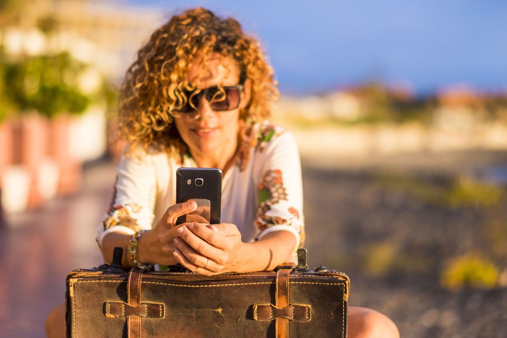Woman using a phone abroad because she has a Travel eSIM