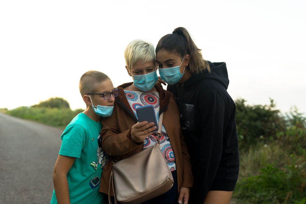Family of three wearing masks and following travel safety advice in Europe