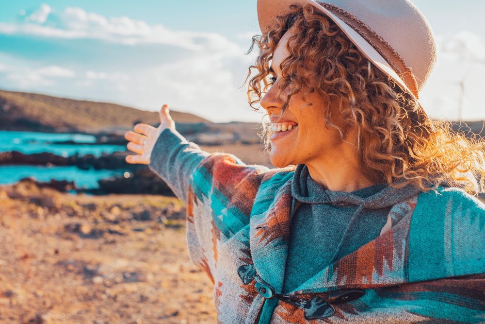 woman with her arms open enjoying the landscape because she followed our travel tips and tricks