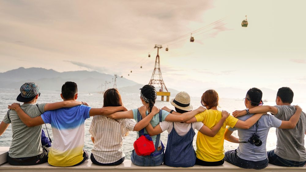 Friends holding while looking into the horizon, representing the Best Group Travel App