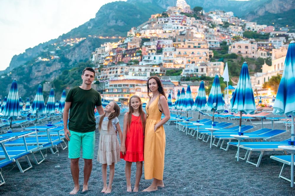Family in a beach in Positano on a Italy Family Trip