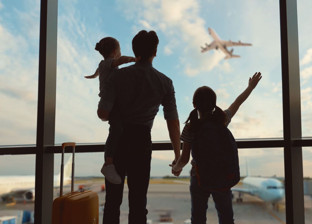 A father and two children at the airport, after following Packing Tips for Family Travelling