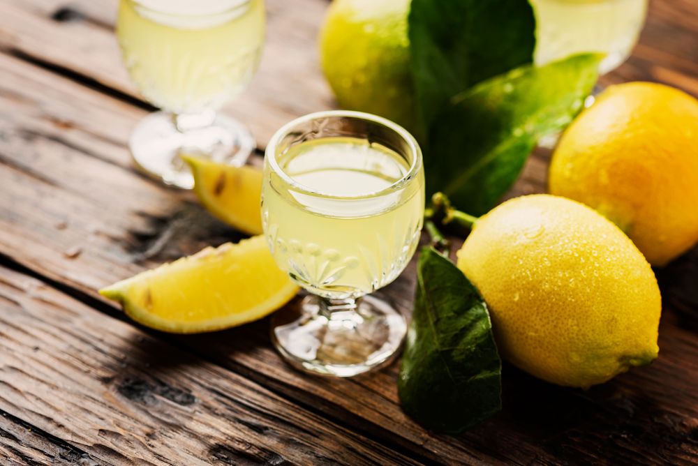 limoncello glass between lemons