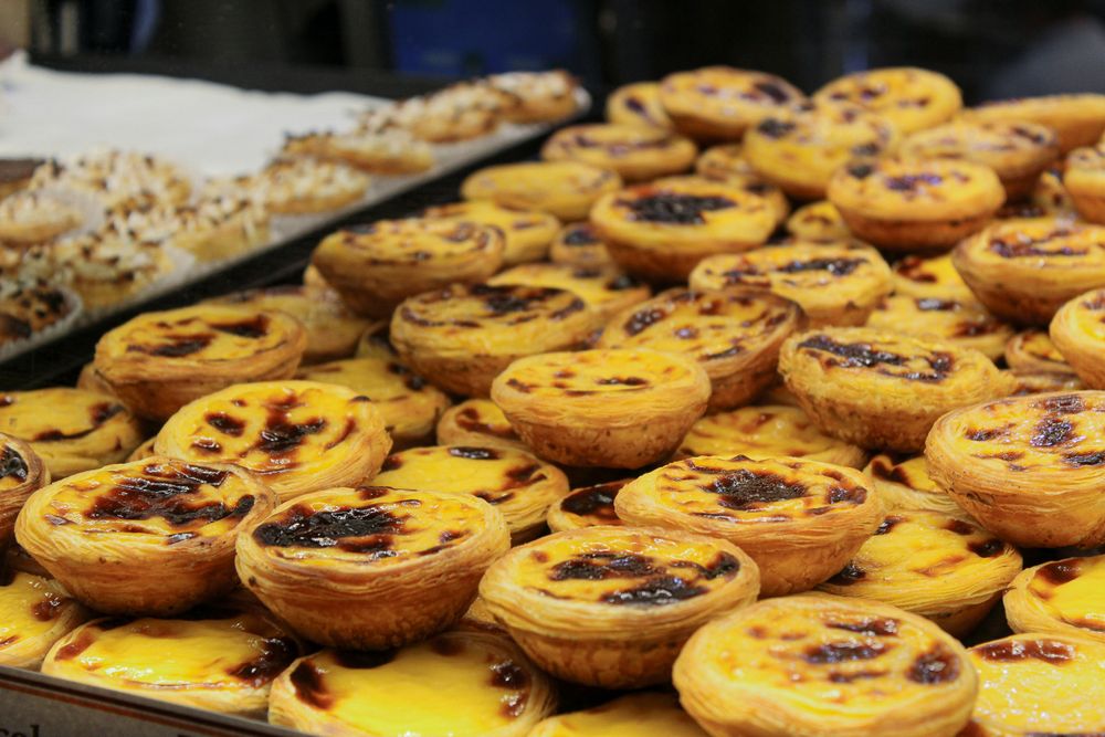 Pasteis de Nata or Portuguese custard tarts in a shop in Lisbon, one of the 10 Must-Visit Foodie Destinations Around the World