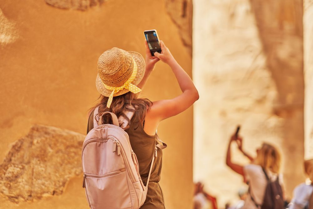 Tourist using her mobile phone abroad because she has a Travel eSIM