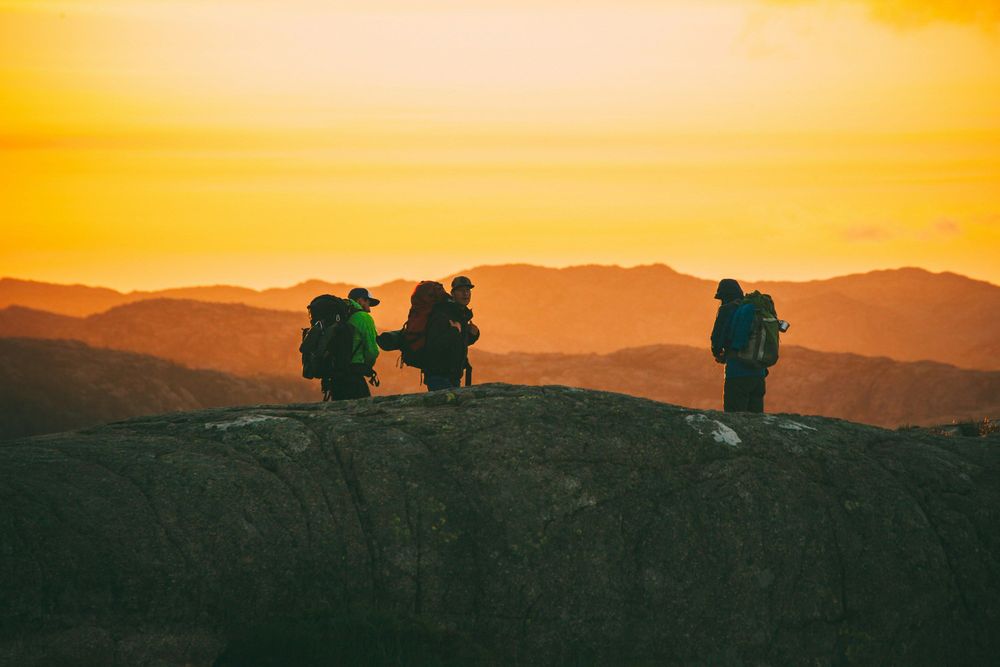 Backpackers in the Mountains representing The Best Money Saving Travel Hacks to Have in 2025: 6 Things You Need to Know
