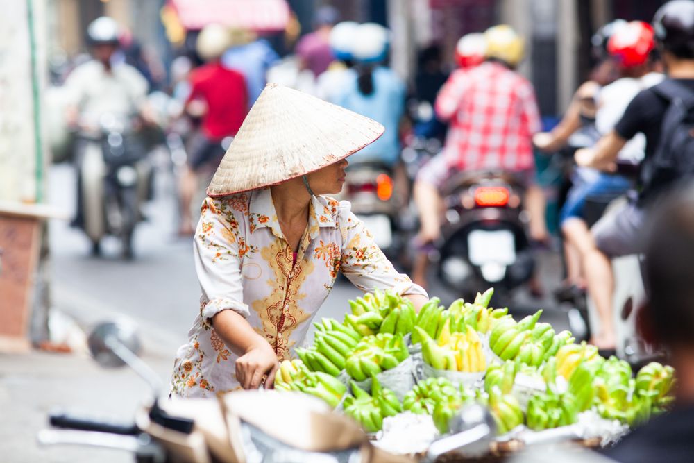 Woman in a market in Ho Chi Minh City, Vietnam one of the Must-Visit Foodie Destinations in Southeast Asia