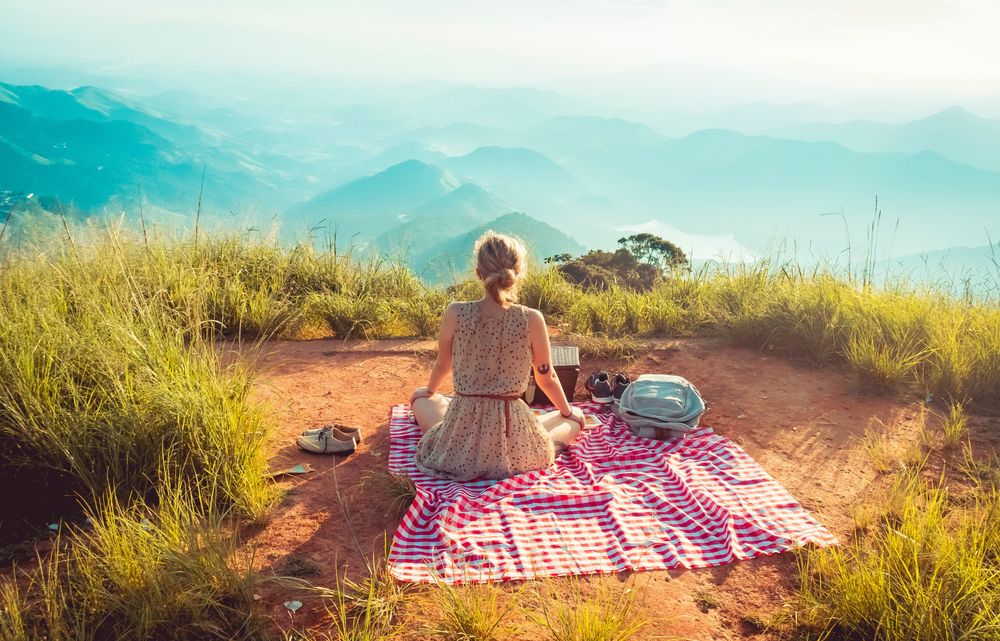 Woman sitting and having a picnic, representing the 10 Must-Visit Foodie Destinations Around the World