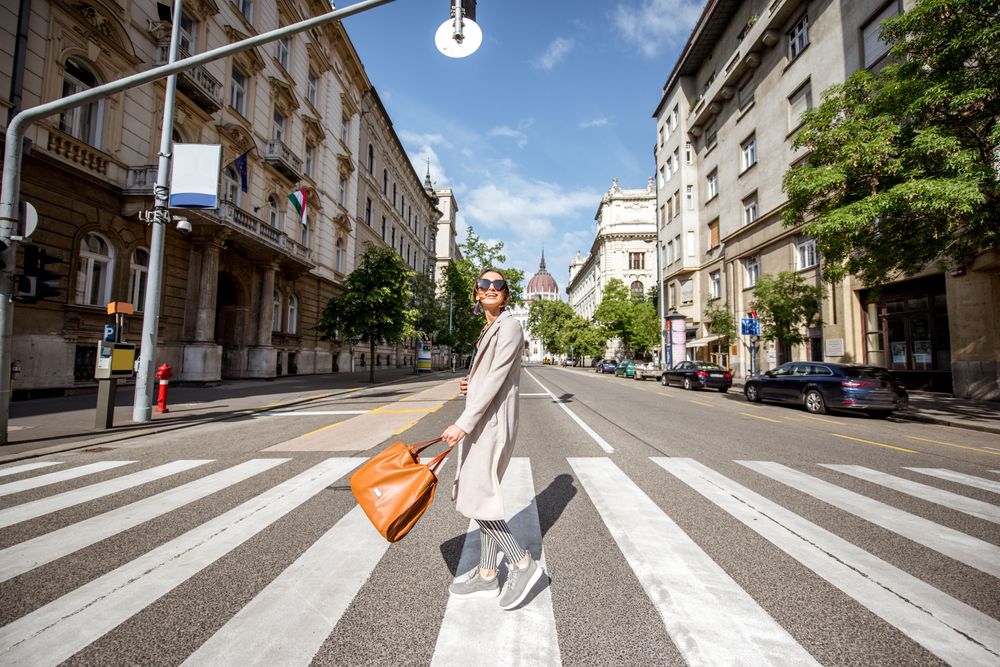 Woman crossing a street, representing Stippl, the best travel planning app for 2024