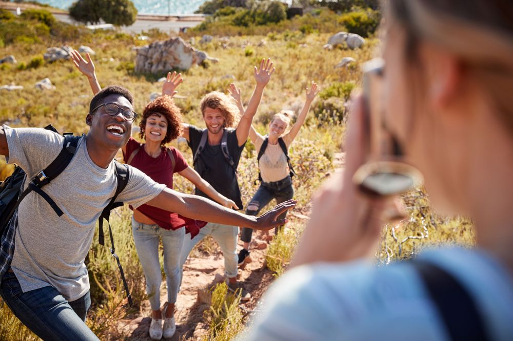 Friends enjoying themselves taking a picture because they know how to make the best out of a vacation planner app
