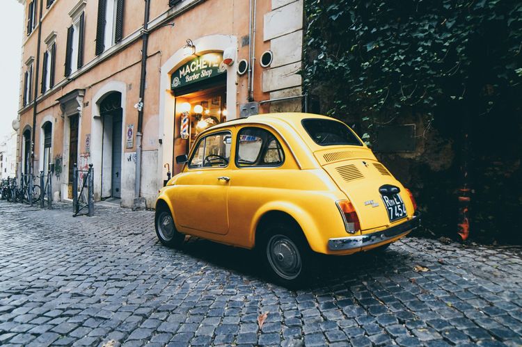 An old car in Rome representing how to of from Rome to Florence