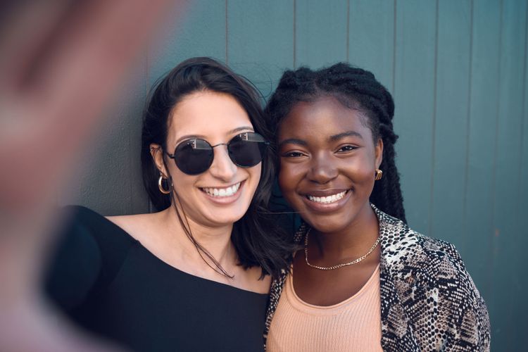 Two women smiling for selfie because they know about Stippl, the best Travel Itinerary App