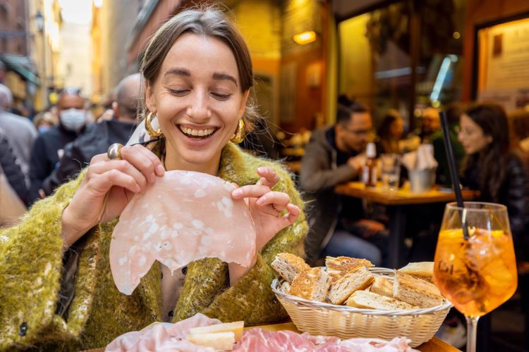 Woman eating in Italy representing Food Experiences in Italy